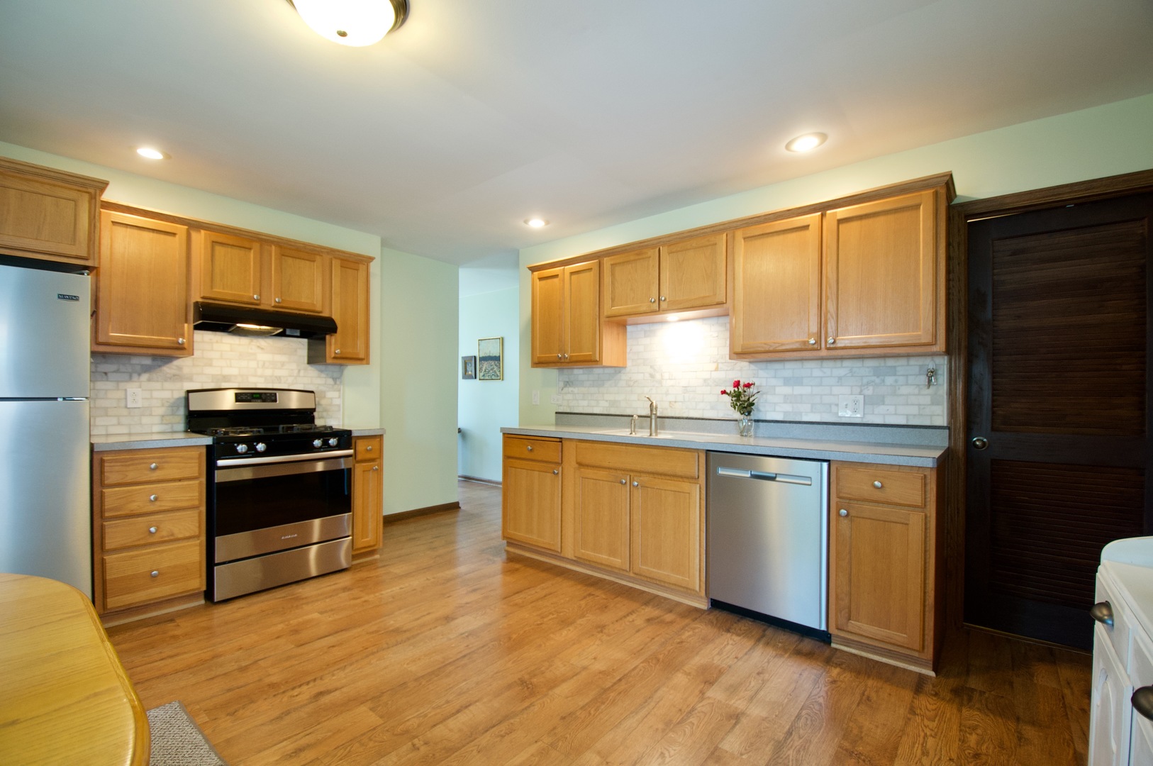 150 Heathgate Road Montgomery, IL 60538 - Photo 4 of 25 a kitchen with granite countertop a refrigerator stove top oven and sink