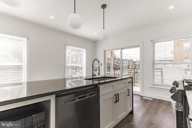a kitchen with granite countertop a sink and a window