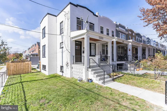a front view of a house with a yard table and chairs