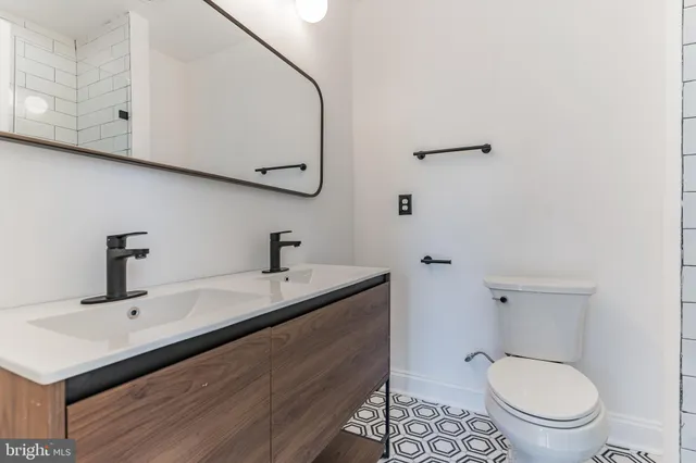 a bathroom with a sink toilet and vanity