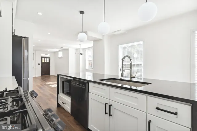 a kitchen with a sink stove and refrigerator
