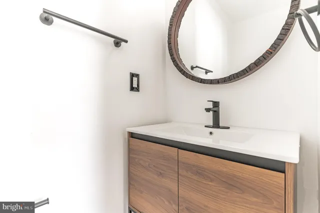 a bathroom with a sink and mirror