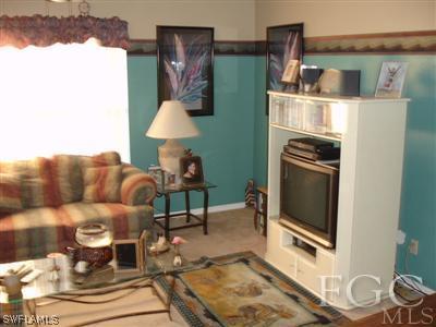 17517 Homewood Road Fort Myers, FL 33967 - Photo 3 of 9 a living room with furniture and a fireplace
