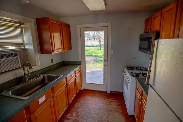 a kitchen with stainless steel appliances granite countertop a refrigerator and a stove