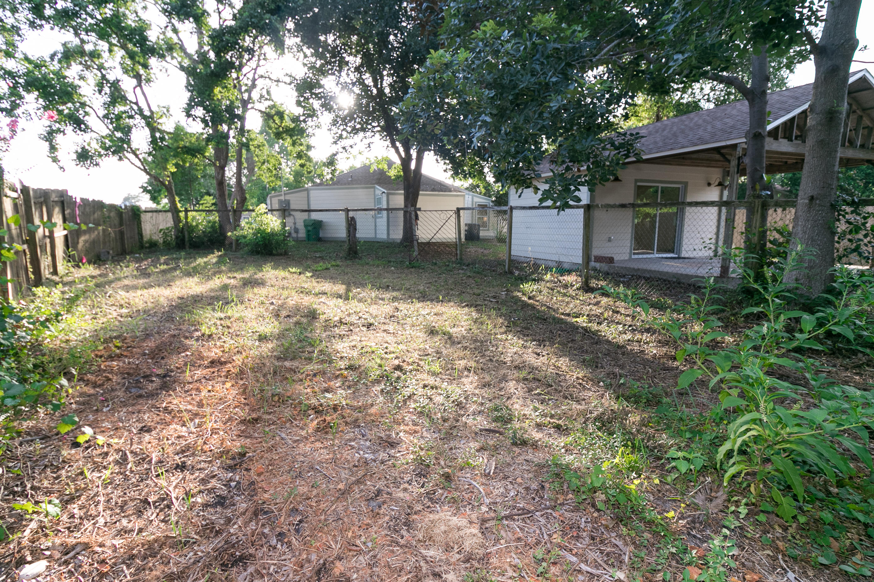 502 3rd Avenue Destin, FL 32541 - Photo 16 of 18 a backyard of a house with lots of green space