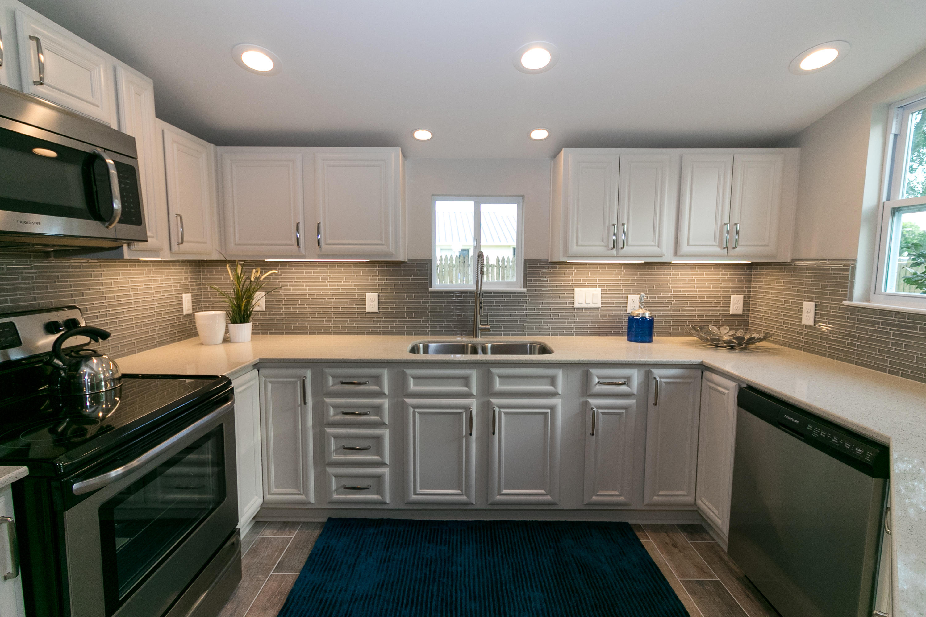 502 3rd Avenue Destin, FL 32541 - Photo 6 of 18 a kitchen with stainless steel appliances granite countertop a stove a sink and a microwave