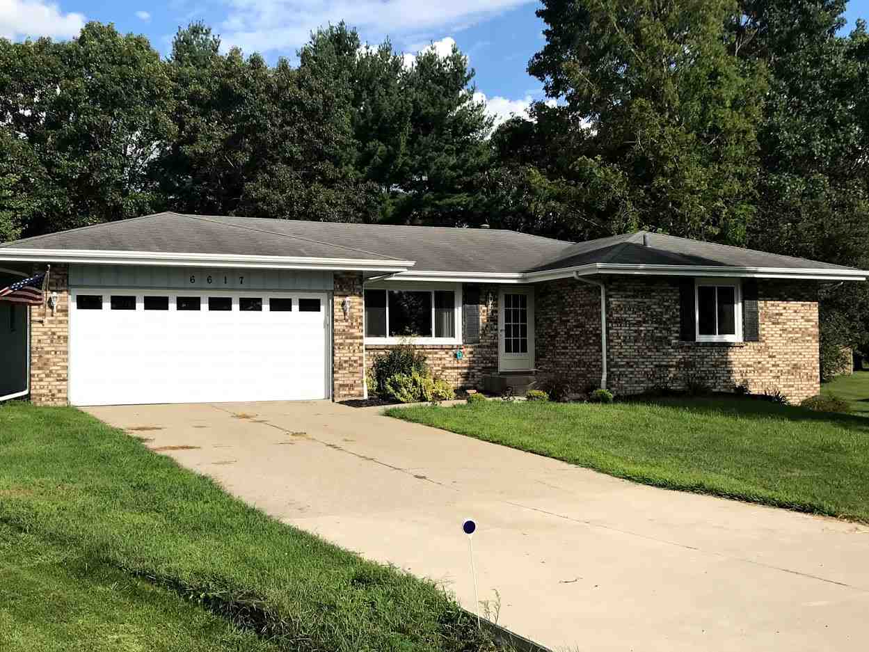 6617 Barkridge Road Roscoe, IL 61073 - Photo 1 of 19 a front view of a house with a yard and garage