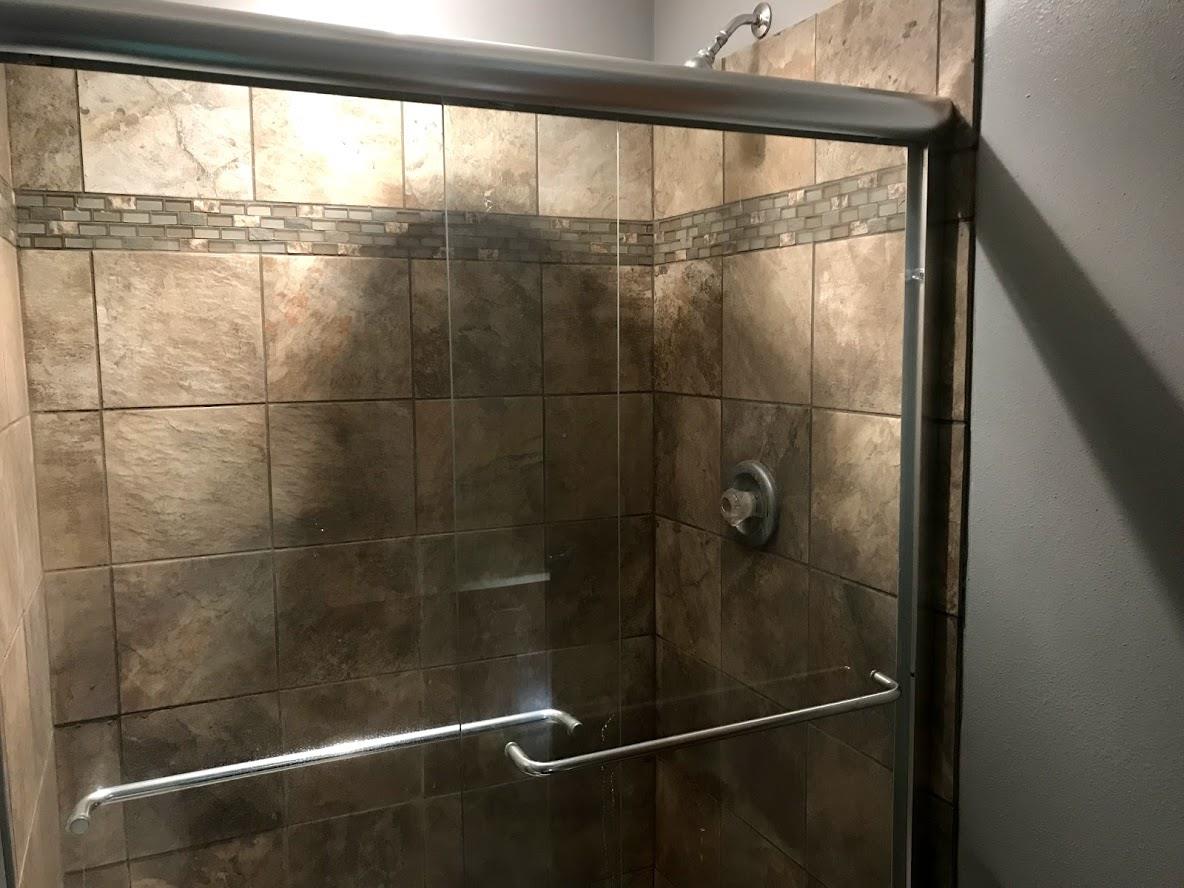 6617 Barkridge Road Roscoe, IL 61073 - Photo 12 of 19 a bathroom with a glass shower door