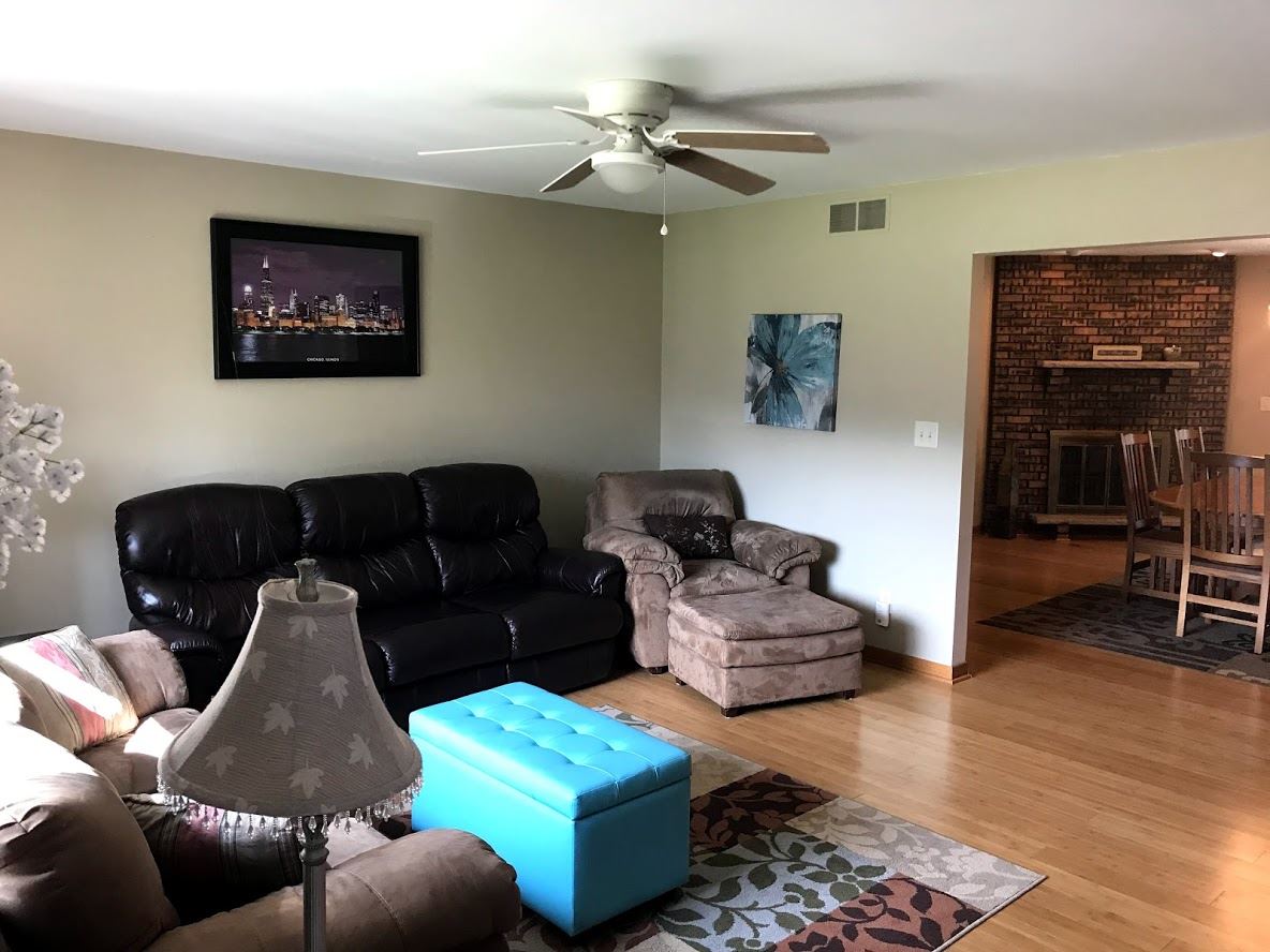 6617 Barkridge Road Roscoe, IL 61073 - Photo 2 of 19 a living room with furniture and a rug