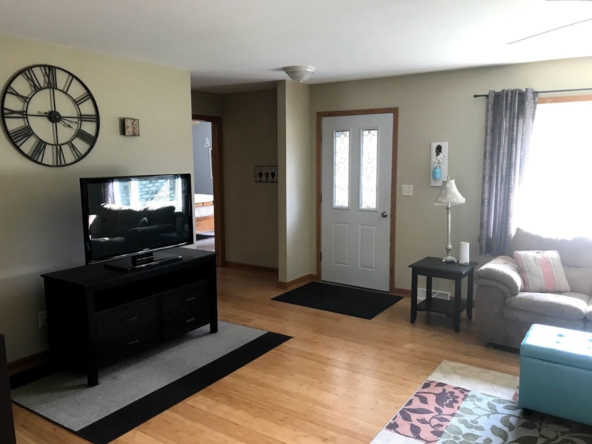 6617 Barkridge Road Roscoe, IL 61073 - Photo 3 of 19 a living room with furniture a flat screen tv and a fireplace