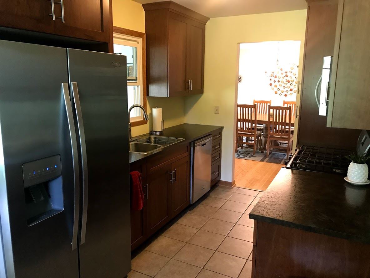 6617 Barkridge Road Roscoe, IL 61073 - Photo 7 of 19 a kitchen with stainless steel appliances granite countertop a refrigerator a stove and a sink