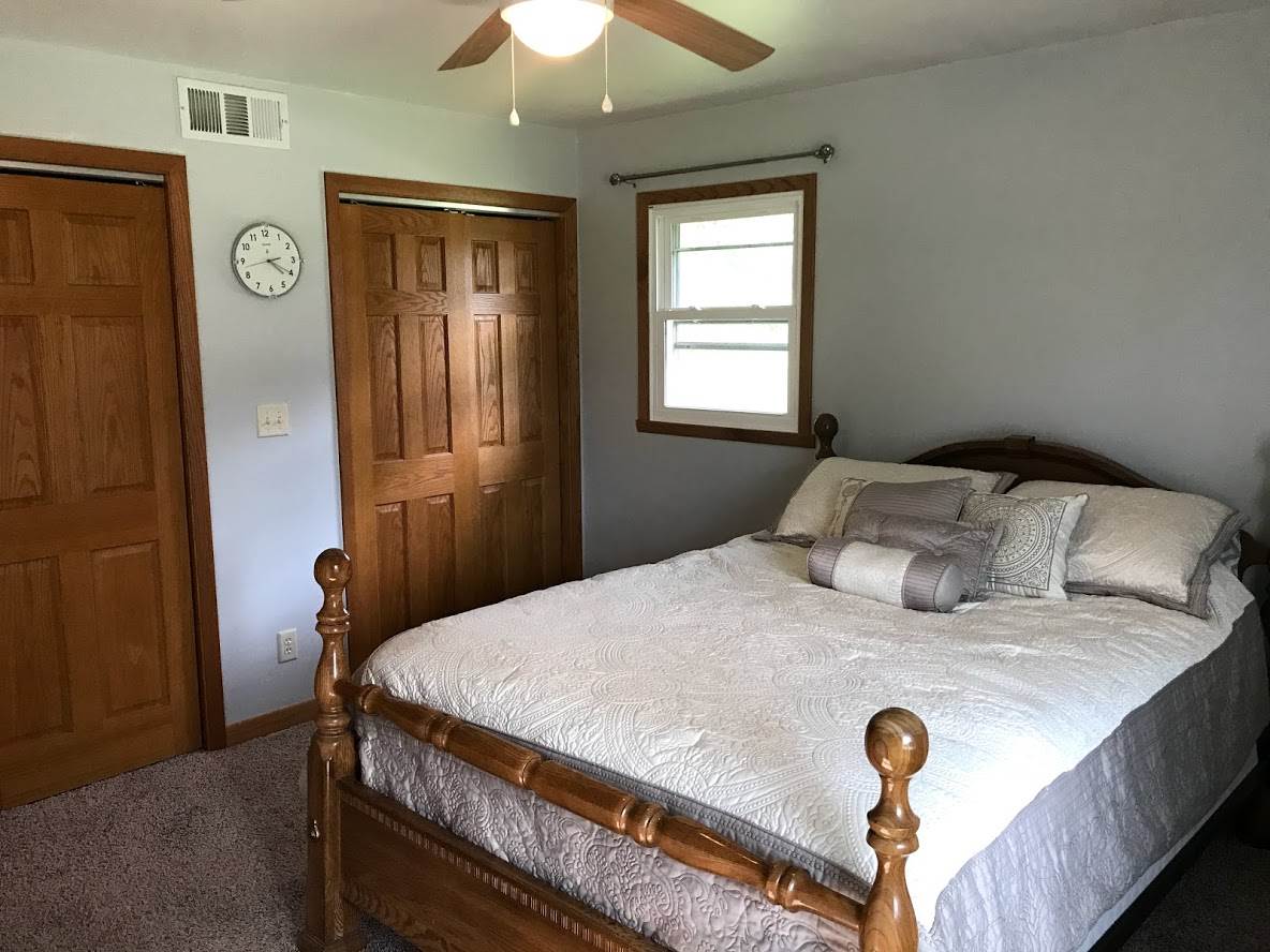 6617 Barkridge Road Roscoe, IL 61073 - Photo 10 of 19 a bedroom with a bed and a chandelier