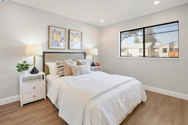 a bedroom with bed and wooden floor