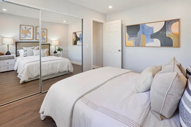 a bedroom with two beds and painting on the wall