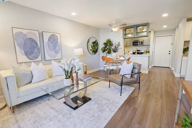 a living room with furniture and wooden floor