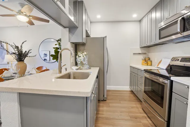 a kitchen with stainless steel appliances a sink a stove and a refrigerator