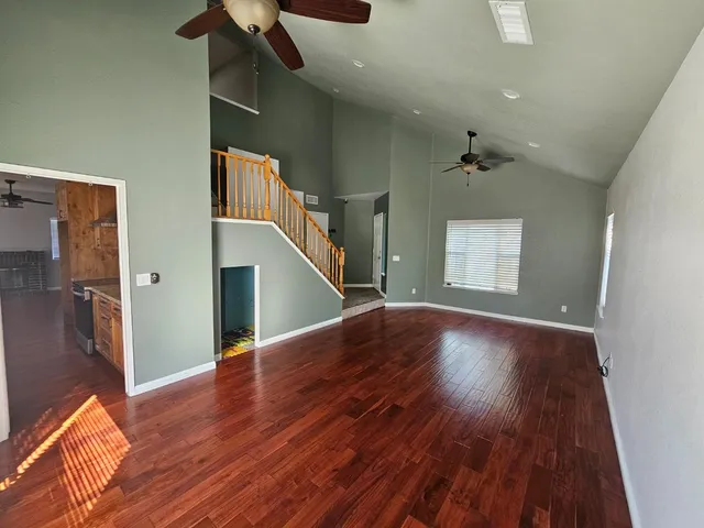 a kitchen with granite countertop wooden cabinets and a stove top oven