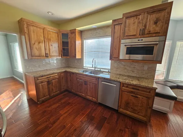 a living room with hardwood floor and a window
