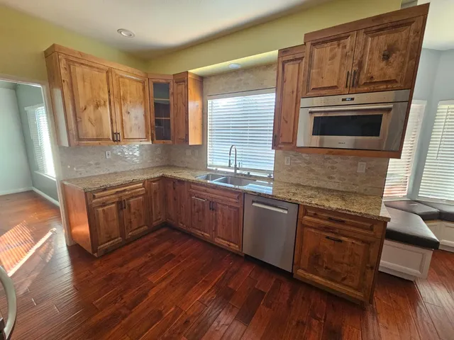 a living room with hardwood floor and a window