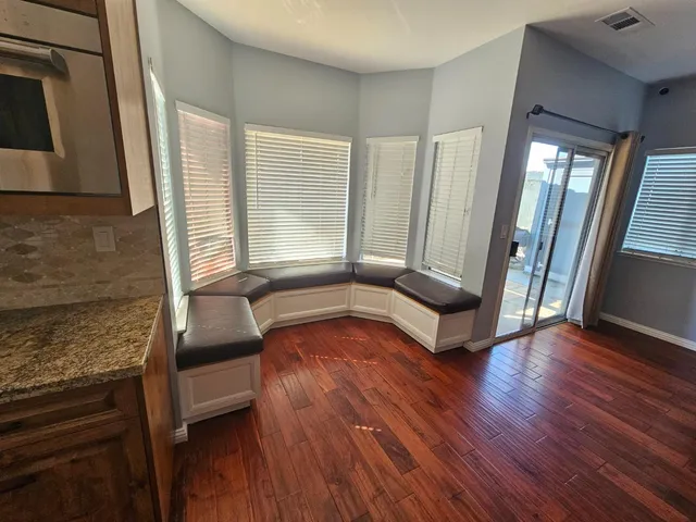 a view of empty room with wooden floor fireplace and windows