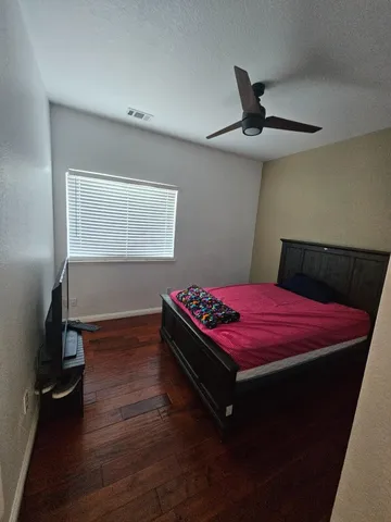 a bathroom with a granite countertop sink mirror vanity and toilet