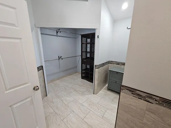 a bathroom with a granite countertop shower and a sink