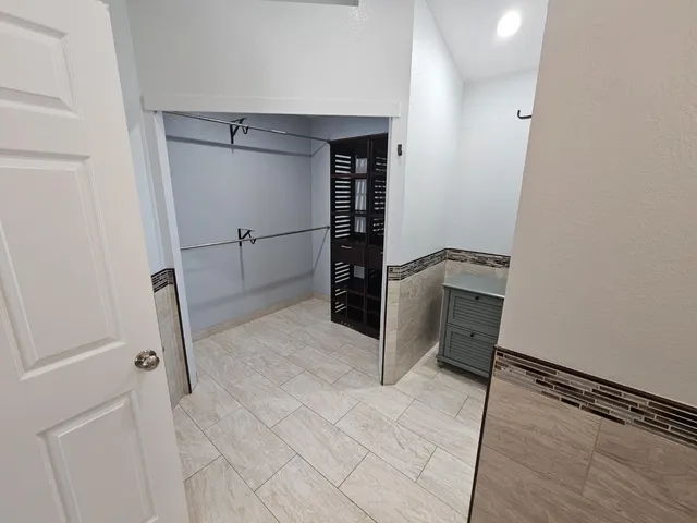 a bathroom with a granite countertop shower and a sink