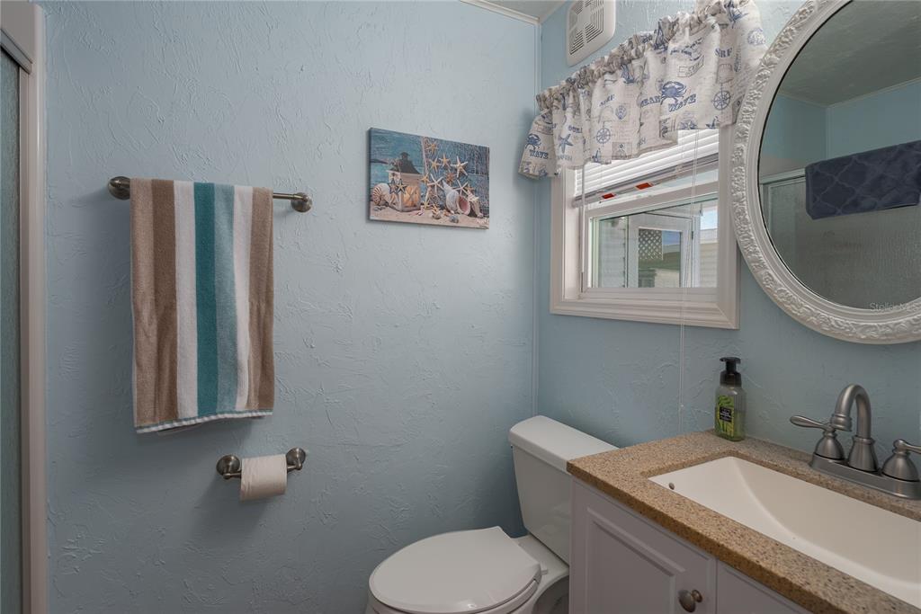 1416 41st Avenue East Ellenton, FL 34222 - Photo 12 of 26 a bathroom with a toilet sink and mirror