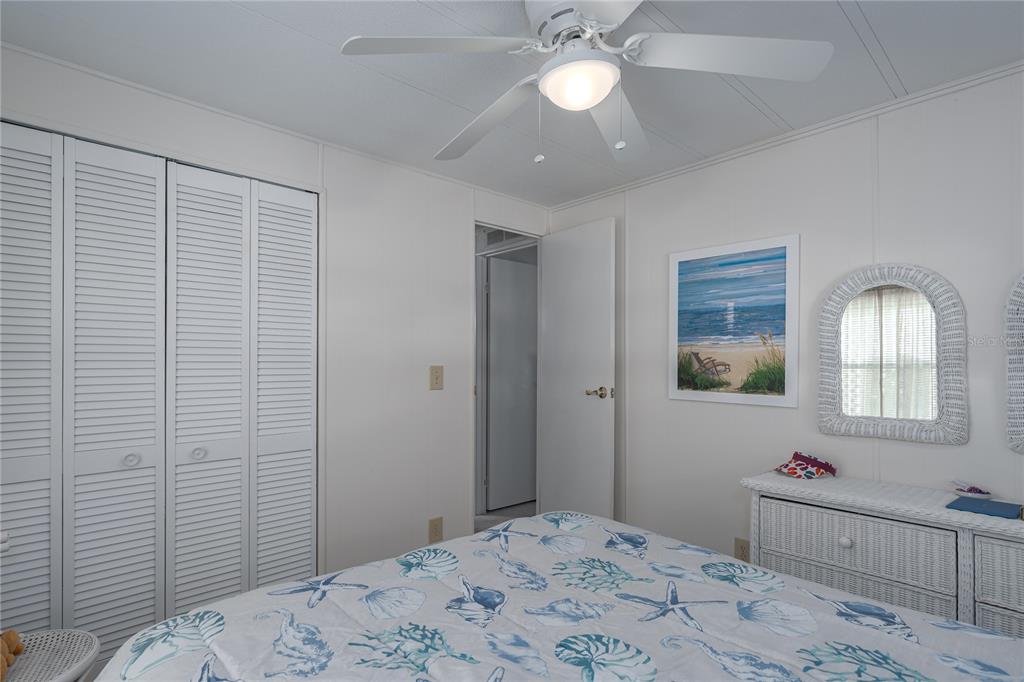1416 41st Avenue East Ellenton, FL 34222 - Photo 14 of 26 a bedroom with a bed and a chandelier