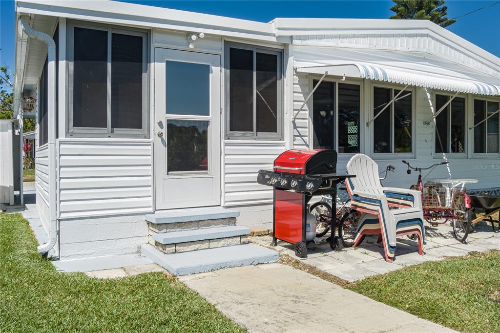 1416 41st Avenue East Ellenton, FL 34222 - Photo 18 of 26 front view of a house with chairs and a cycle