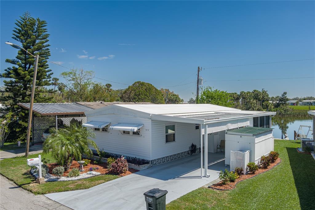 1416 41st Avenue East Ellenton, FL 34222 - Photo 19 of 26 a view of a patio with table and chairs potted plants with wooden floor and fence