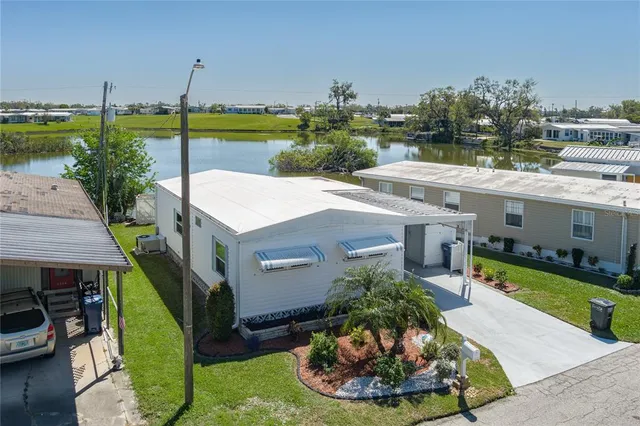 a view of a house with swimming pool and a yard