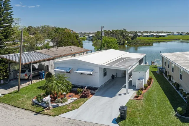 an aerial view of a house with garden space and lake view