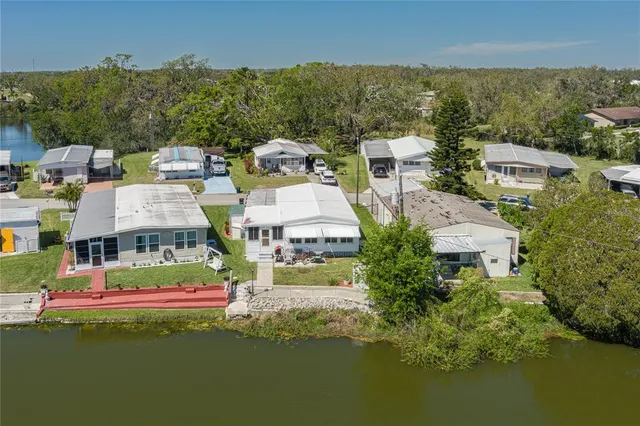 an aerial view of residential houses with outdoor space and swimming pool