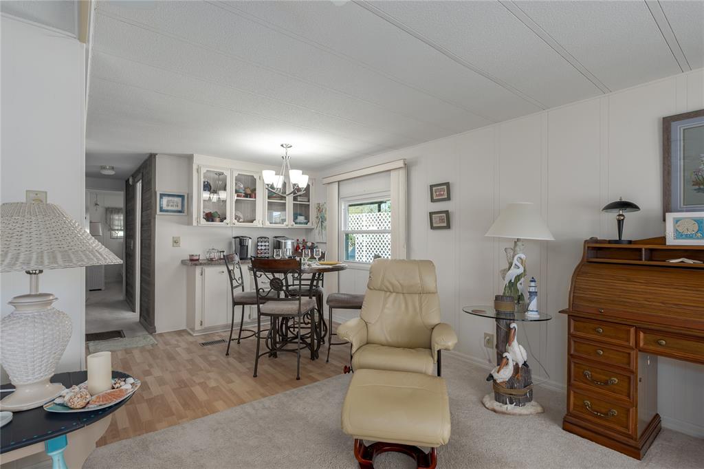 1416 41st Avenue East Ellenton, FL 34222 - Photo 7 of 26 a living room with furniture and a dining table with lamp