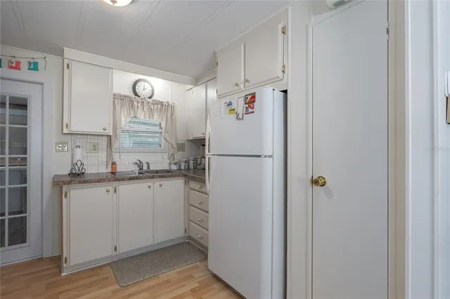 a white refrigerator freezer sitting inside of a kitchen