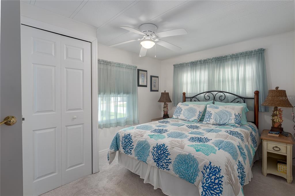 1416 41st Avenue East Ellenton, FL 34222 - Photo 10 of 26 a bedroom with a bed and a chandelier