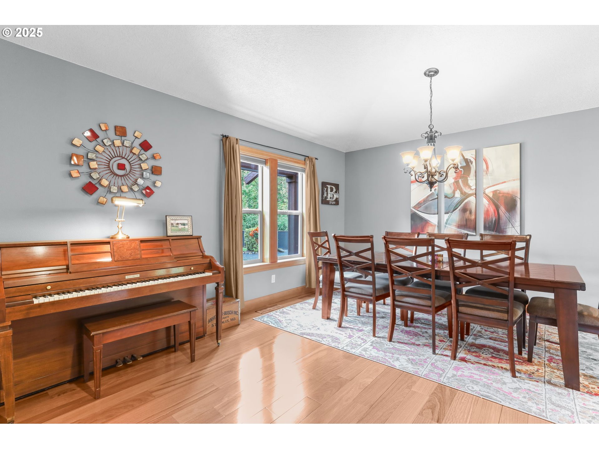 8443 Southeast Orient Drive Gresham, OR 97080 - Photo 14 of 48 a dining room with furniture a rug and a chandelier