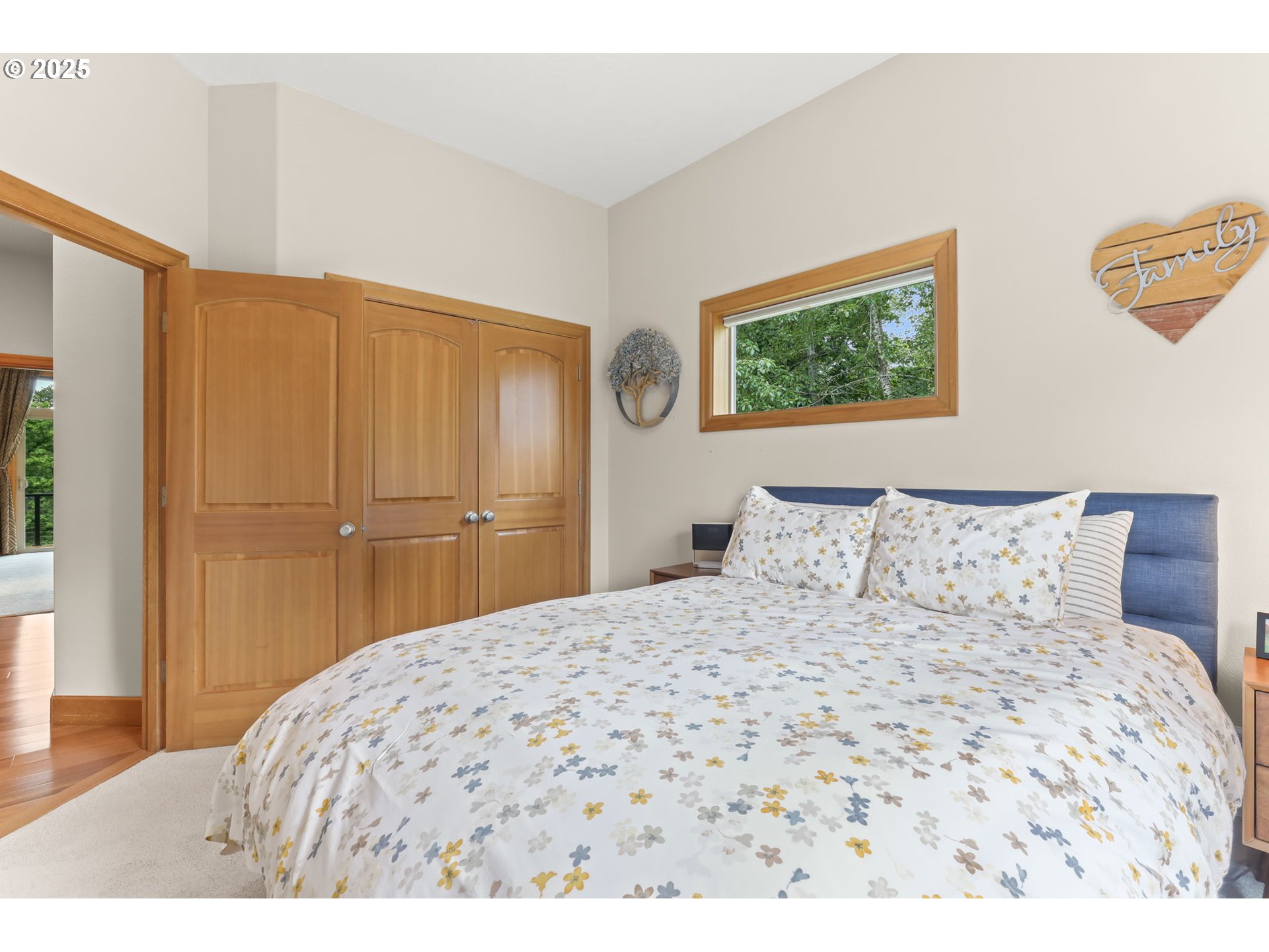 8443 Southeast Orient Drive Gresham, OR 97080 - Photo 21 of 48 a bedroom with a large bed and a painting on the wall