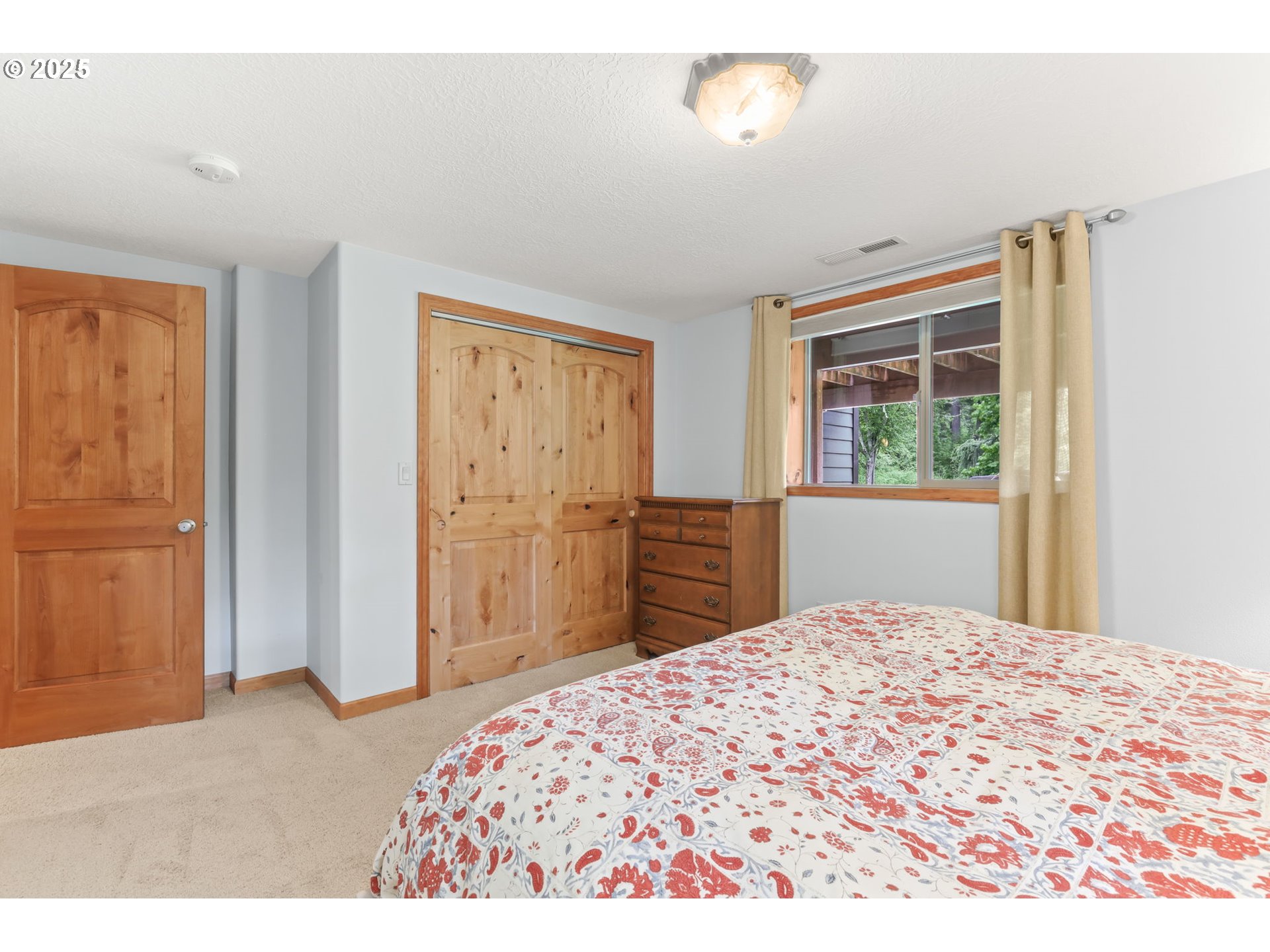 8443 Southeast Orient Drive Gresham, OR 97080 - Photo 37 of 48 a bedroom with a large bed and a window