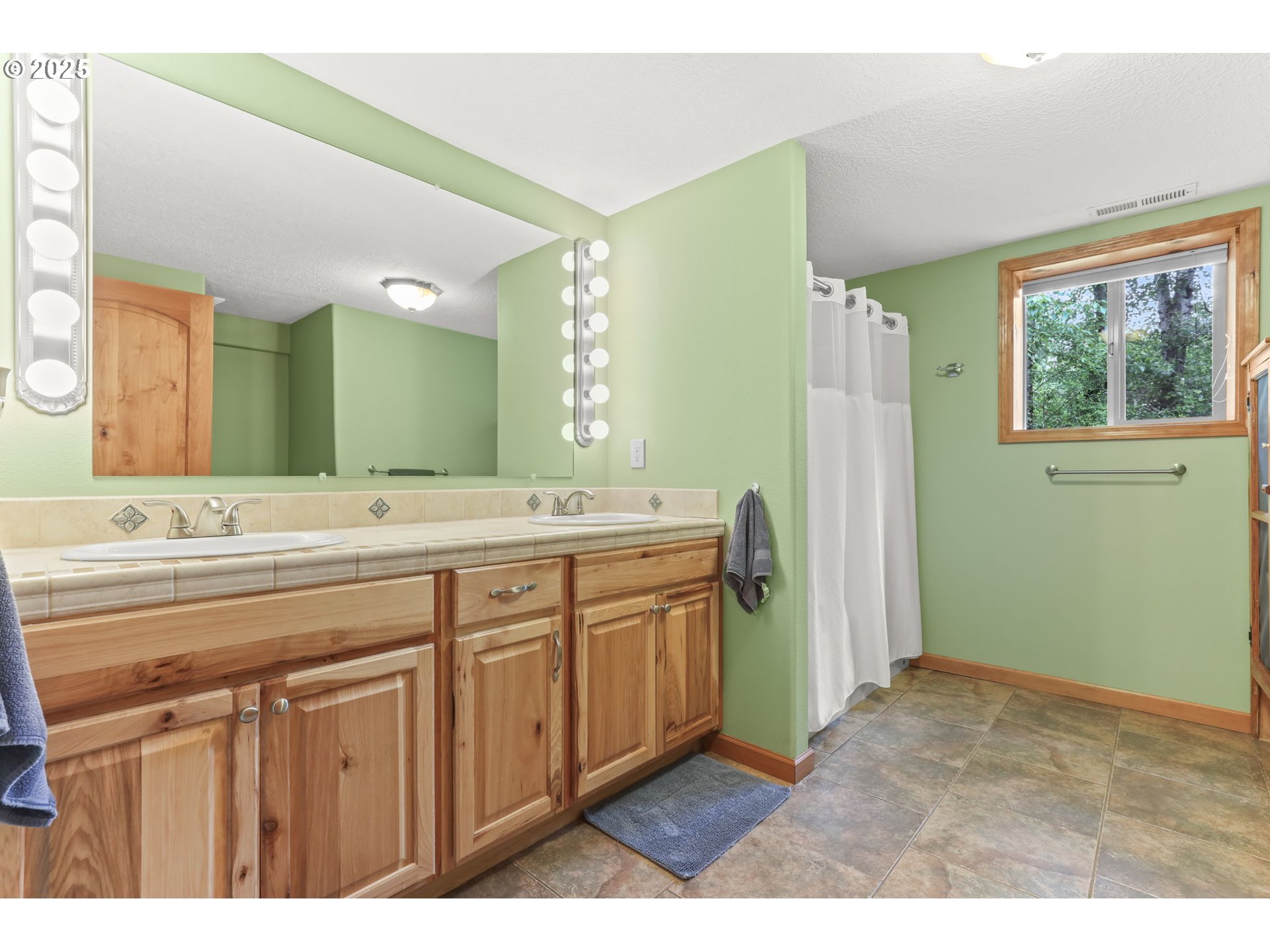8443 Southeast Orient Drive Gresham, OR 97080 - Photo 38 of 48 a bathroom with a double vanity sink and a mirror