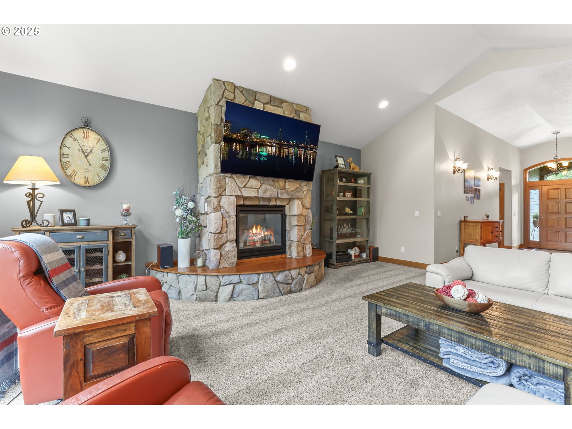 8443 Southeast Orient Drive Gresham, OR 97080 - Photo 6 of 48 a living room with furniture a flat screen tv and a fireplace