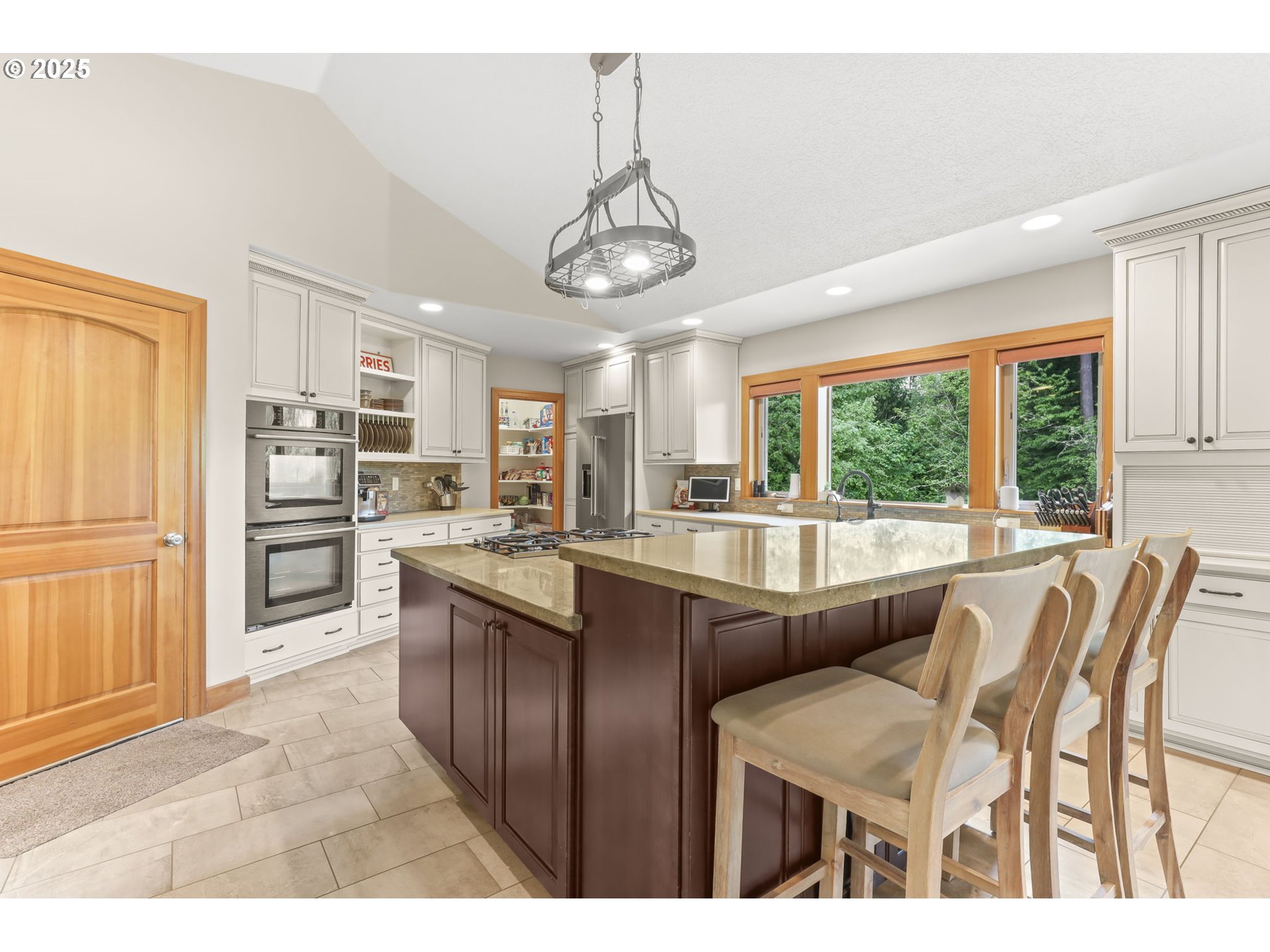 8443 Southeast Orient Drive Gresham, OR 97080 - Photo 9 of 48 a kitchen with stainless steel appliances granite countertop a stove top oven a sink dishwasher and a refrigerator with wooden floor