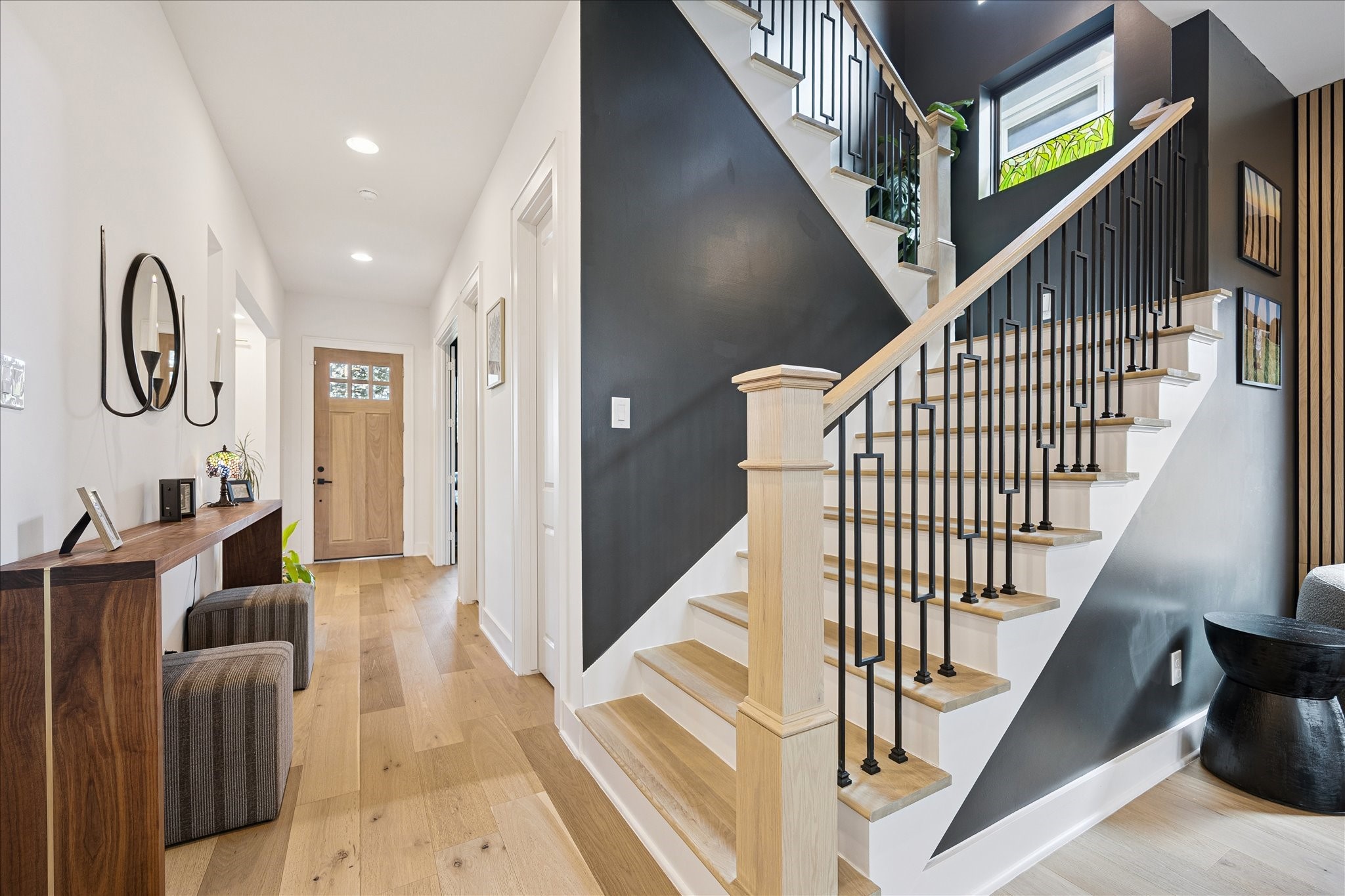 1313 Thornton Road Houston, TX 77018 - Photo 8 of 32 A dramatic entry welcomes you with soaring ceilings, wide-plank hardwood flooring, and a striking staircase that sets the tone for the home's sophisticated design.