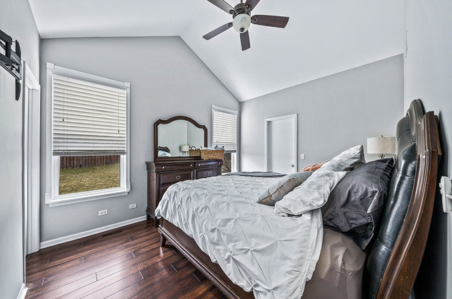 2904 Arbor Lane Aurora, IL 60502 - Photo 14 of 23 a bedroom with a bed and a dresser with wooden floor