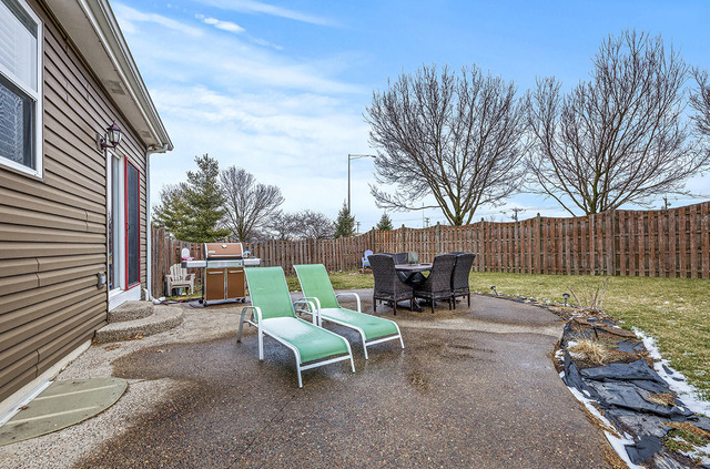 2904 Arbor Lane Aurora, IL 60502 - Photo 20 of 23 a view of backyard with outdoor seating and trees in the background