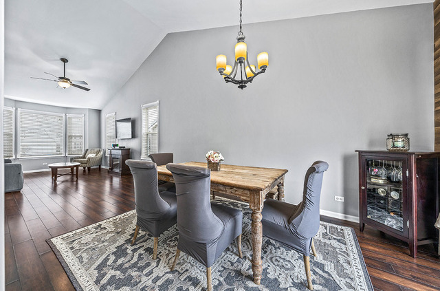 2904 Arbor Lane Aurora, IL 60502 - Photo 8 of 23 a view of a dining room and livingroom with furniture wooden floor a rug and a chandelier