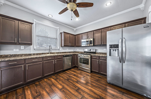 2904 Arbor Lane Aurora, IL 60502 - Photo 9 of 23 a kitchen with granite countertop stainless steel appliances cabinets a sink and a counter top space