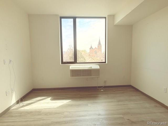 603 Inca Street, Unit 309 Denver, CO 80204 - Photo 7 of 12 a view of empty room with wooden floor and fan