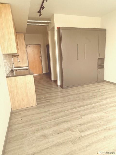 603 Inca Street, Unit 309 Denver, CO 80204 - Photo 8 of 12 a view of a kitchen from the hallway